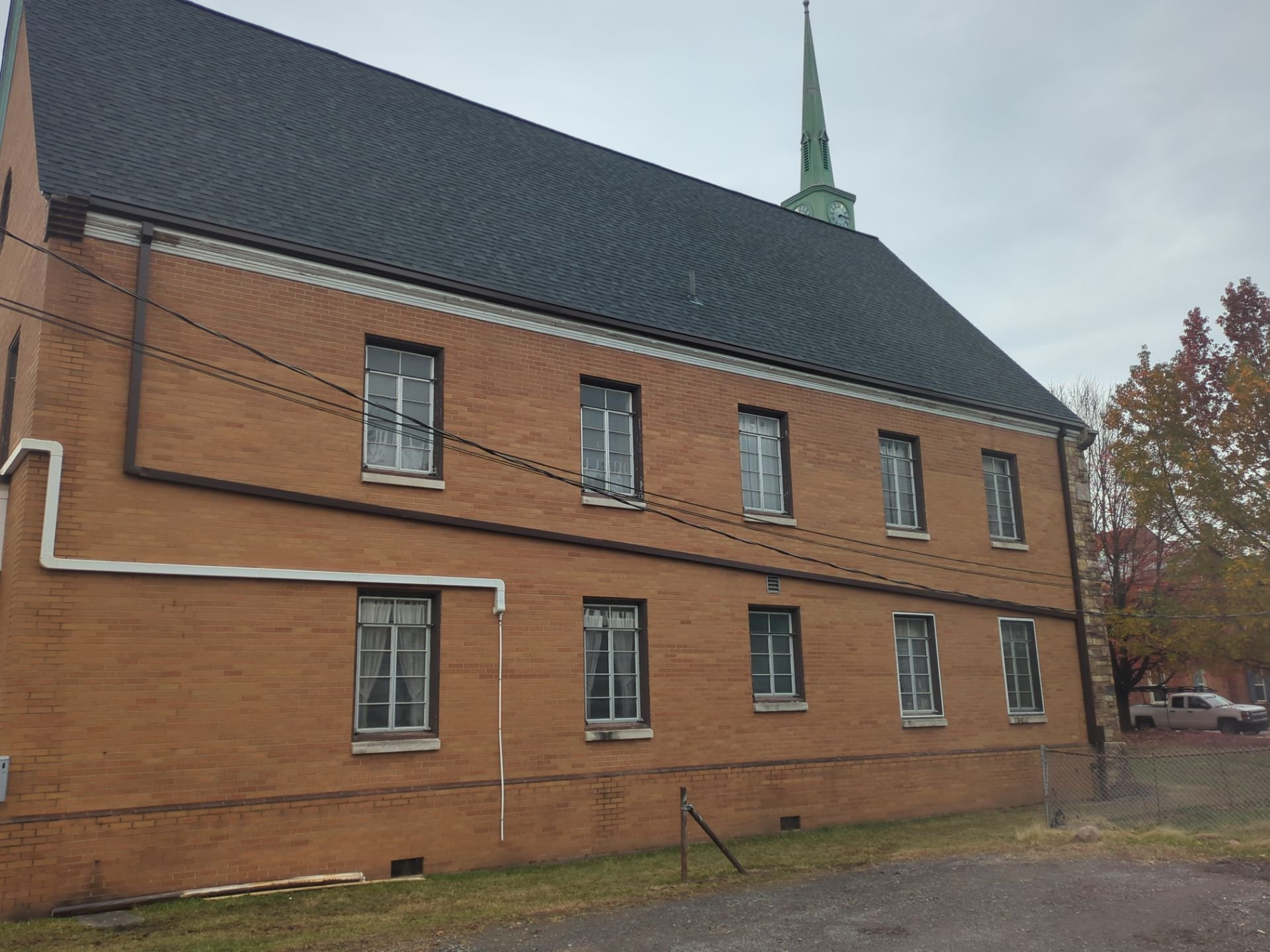Historic church roof replacement using Owens Corning Duration shingles in black with new gutters